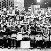 Tinplate Workers The photograph shows a group of boys and young male workers at the Kidwelly Tinplate Works in around 1900. They were recruited to work mainly in the cold rolls. As they became older they transferred to other parts of the works. In 1881there were 51 boys and young men working there. There were also 10 boys between 10 and 15 employed.